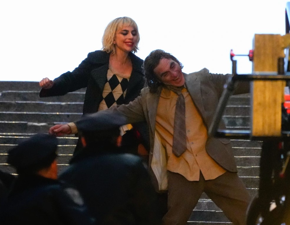 Joker: Folie à Deux (Joker 2) production photos show Lady Gaga and Joaquin Phoenix in full makeup on the first movie iconic concrete stairs.