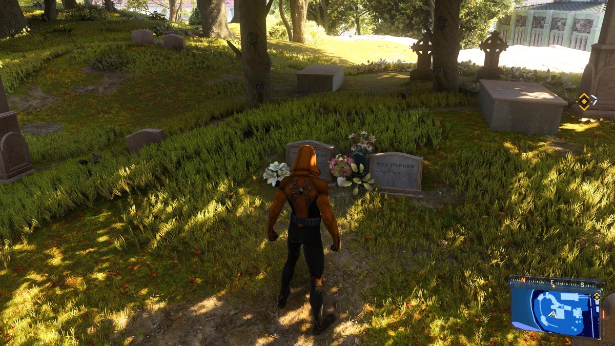 An image showing Peter Parker in his hooded suit standing at the grave of Aunt May and Ben Parker. The article addresses how to find Aunt May's grave in Marvel's Spider-Man 2.