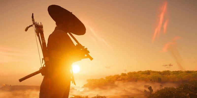 The script for the Ghost of Tsushima movie is complete. The image shows a samurai playing a flute while silhouetted by the setting sun.