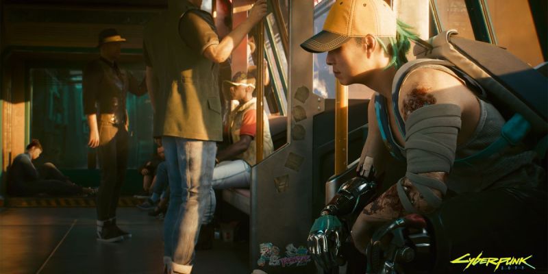 A woman sits on a Metro train in a still from Cyberpunk 2077.