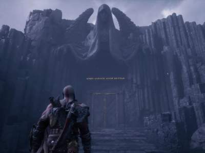 Image of a bald man with ashy skin and an axe on his back gazing up at an angel statue in God of War Ragnarok Valhalla DLC.