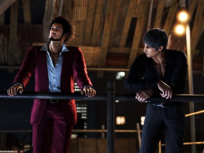 Image of Ichiban and Kiryu leaning on a metal railing overlooking the city at night and talking in Like a Dragon: Infinite Wealth.