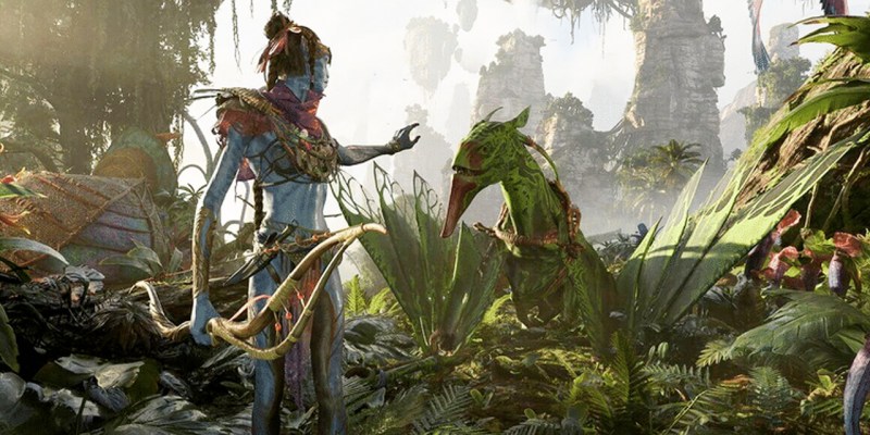 A Na'vi reaching towards a flying animal.