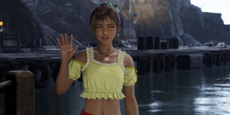 Priscilla in Final Fantay 7 Rebirth. She's wearing a yellow and white top and waving at the screen.