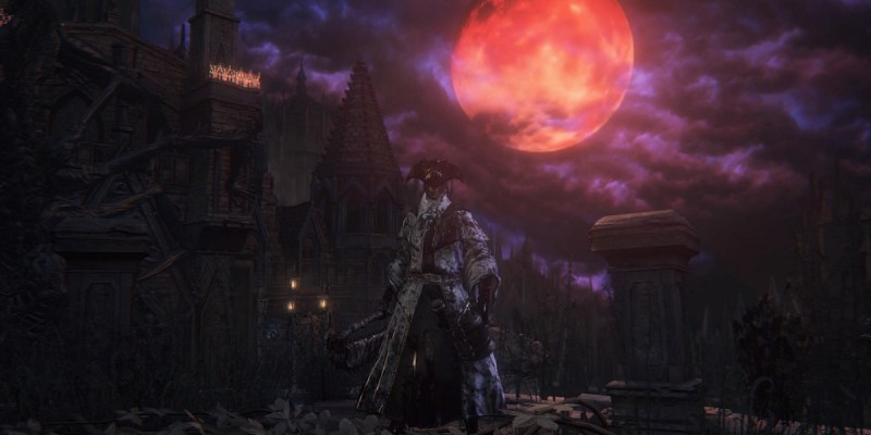 Image of bloodied man wearing a tricorn hat and priestly clothes with a blood moon in the sky in Bloodborne.