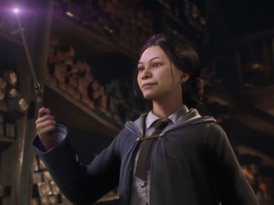 A girl holding up a glowing wand.