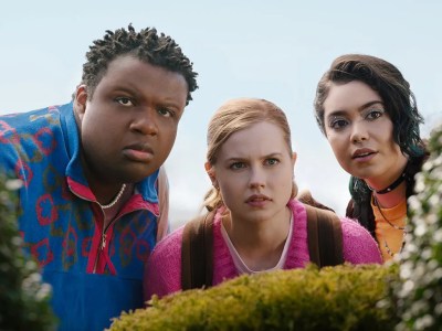 Characters standing behind a hedge in the Mean Girls musical movie.