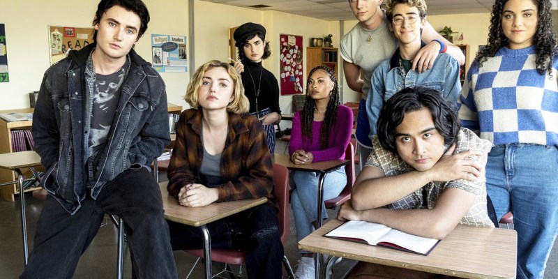 Several people sitting in a classroom, with different styles of dress.