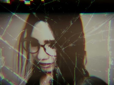 Silent Hill: The Short Message. A girl with glasses in a scratched-out photograph.